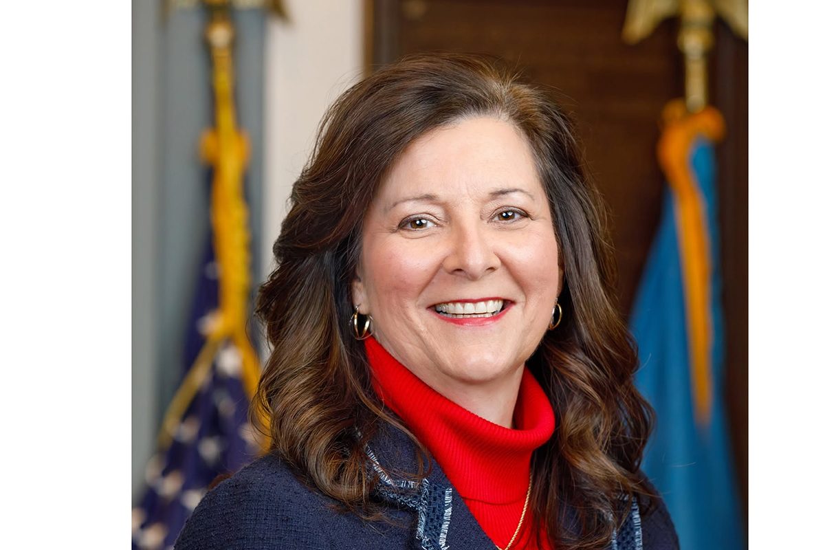 Rep. Valerie Jones Giltner's professional headshot in front of the US and Delaware State flags.